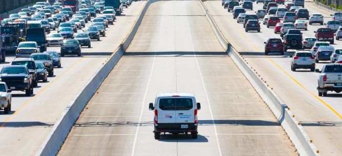 METRO Vanpool vehicle in HOV express lane on U.S. Highway 59 South with gridlock traffic in both directions.