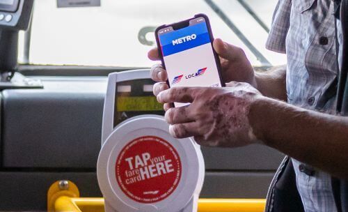 Customer boarding bus with activated METRO Q Mobile Ticket.